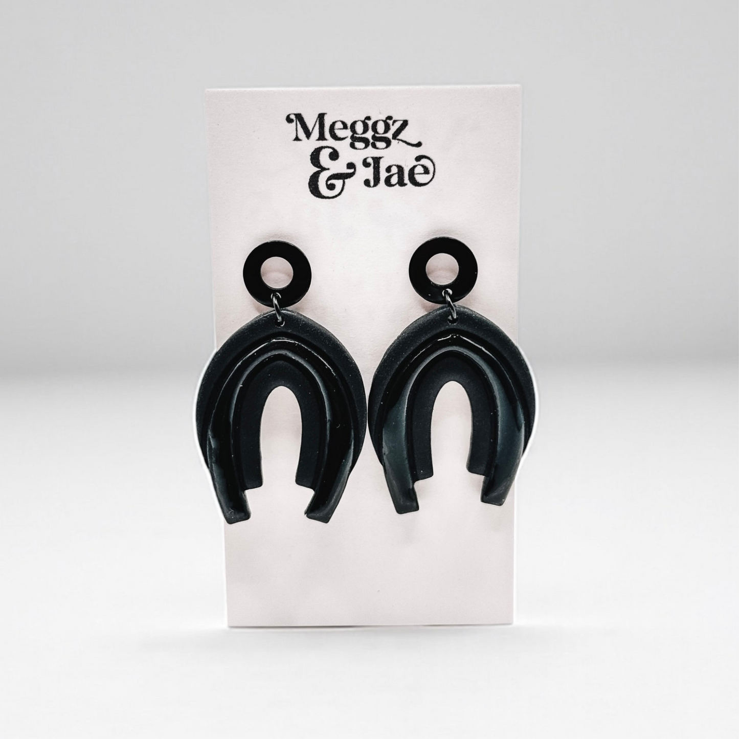 “Serina” black rainbow arch dangles