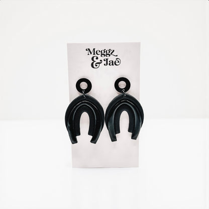“Serina” black rainbow arch dangles